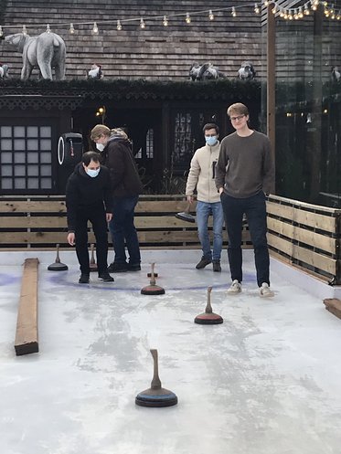 Team members playing curling